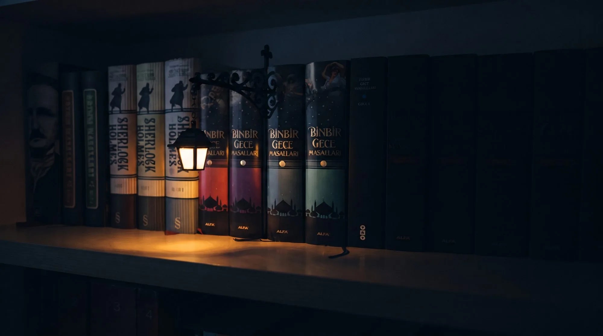 A miniature lantern casting a warm glow across a bookshelf